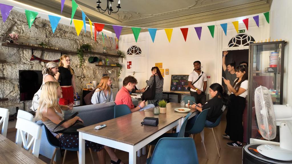 a group of people sitting around a table in a room at Onefam Clerigos in Porto