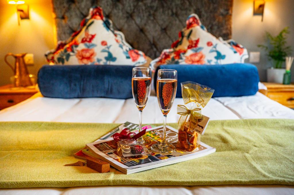a tray with two glasses of champagne on a bed at Crown & Punchbowl in Cambridge