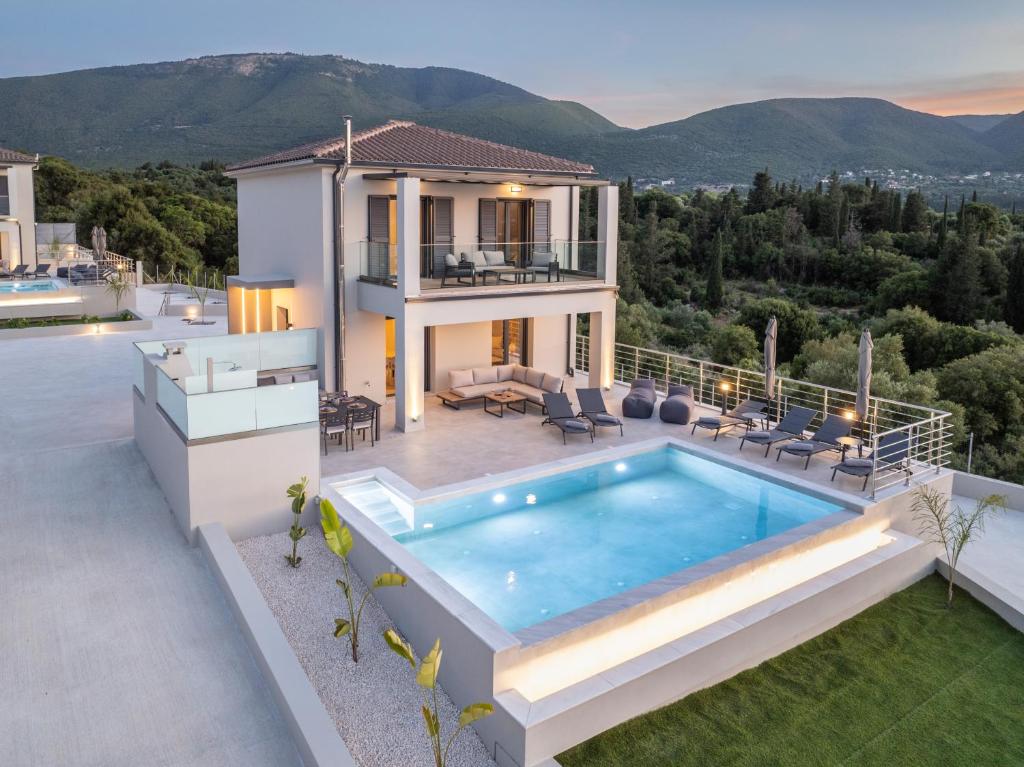a villa with a swimming pool and a house at Agemaya Villas in Sami