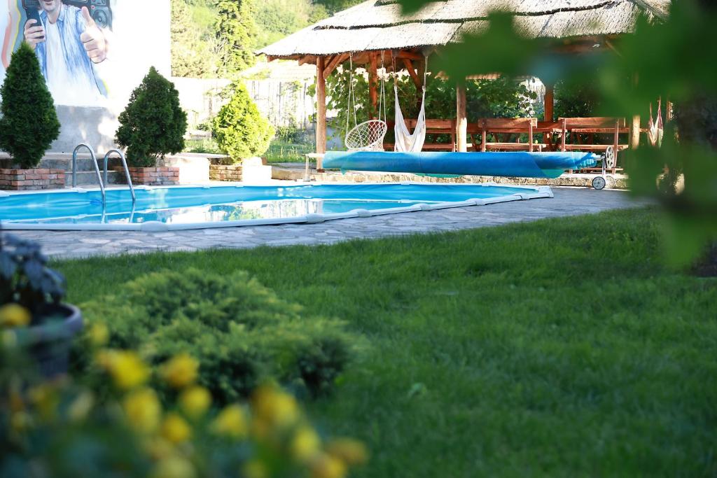 two swimming pools with blue slides in a yard at Sokolovic STD in Lapotince