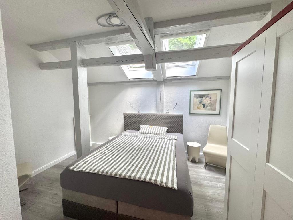 a bedroom with a bed in a room with windows at Brauhaus Suite 19 in Sebnitz