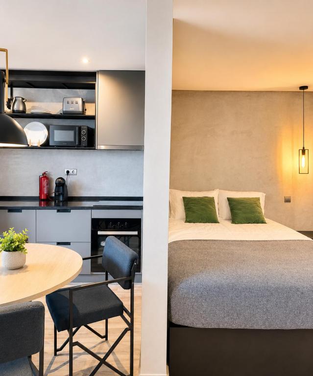 a hotel room with a bed and a table at Fisherman's View in Aveiro