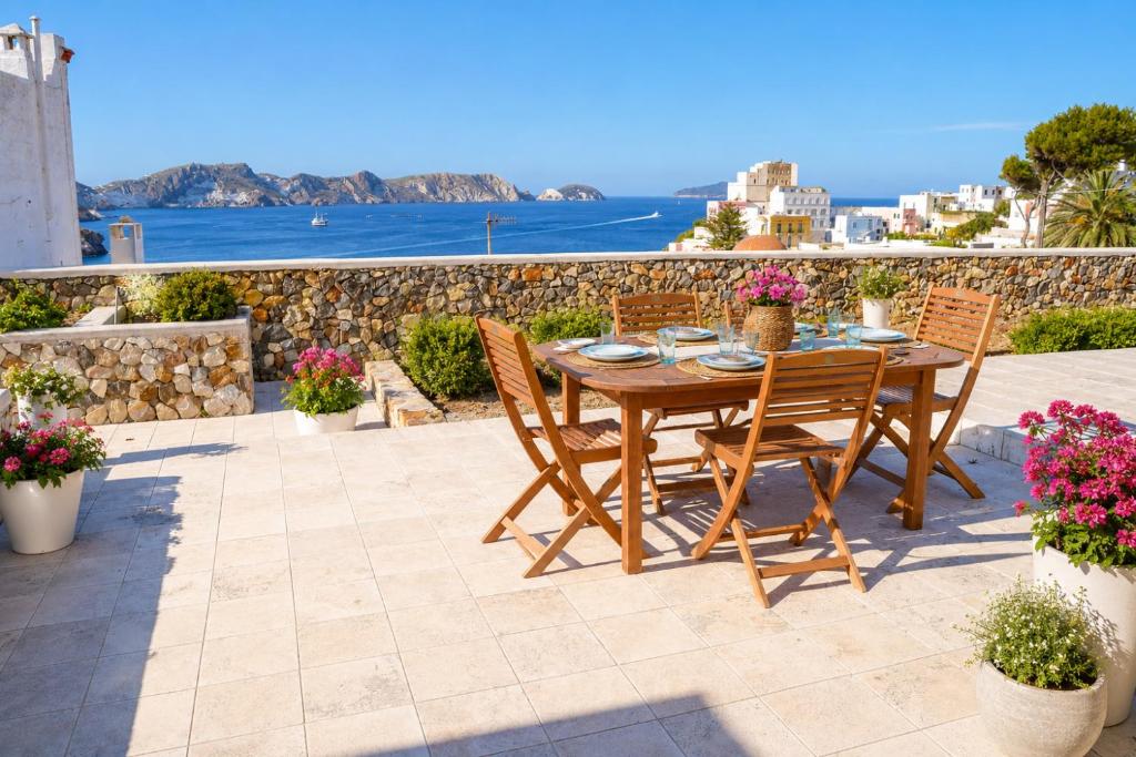 a table and chairs on a patio with a view of the ocean at Maridea - Villa Alta Marea in Ponza