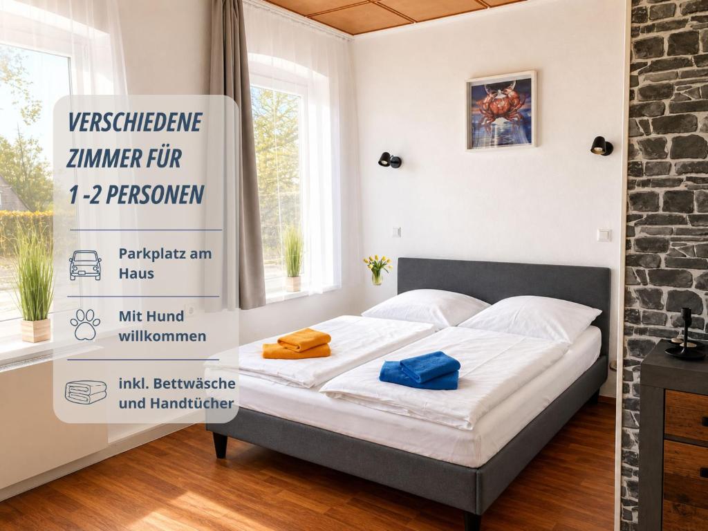 a bed in a room with a sign on the wall at Zimmer Haus Krabbe für Kurzaufenthalt und Geschäftsreise, zwischen Bremerhaven und Cuxhaven in Wremen