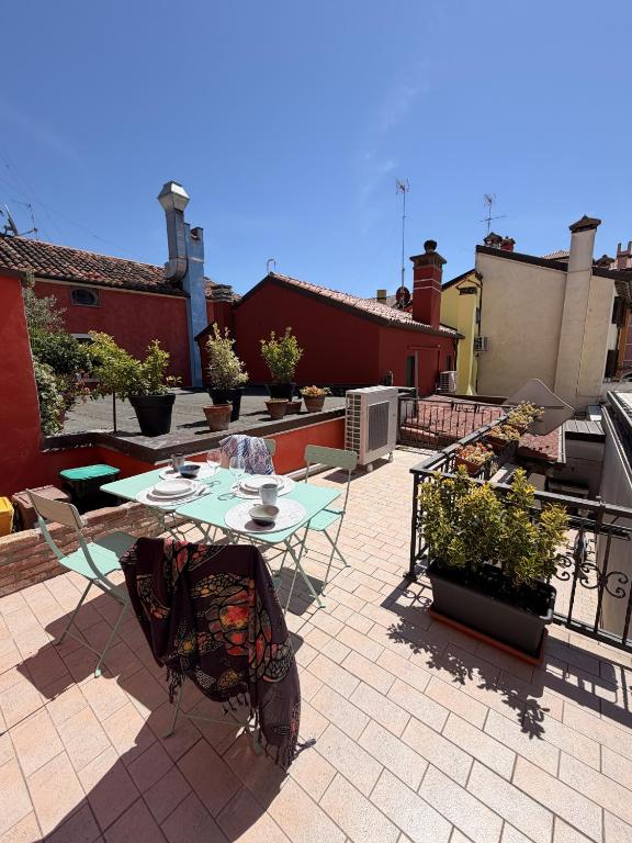 a patio with a table and chairs on a brick patio at Casa Historia in Caorle