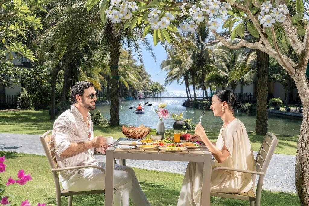 A garden breakfast table beside the resort lagoon.