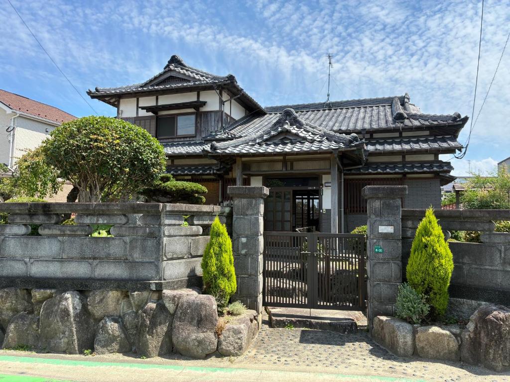a house with a gate in front of it at さつき邸 -Satsuki House- in Fukuoka