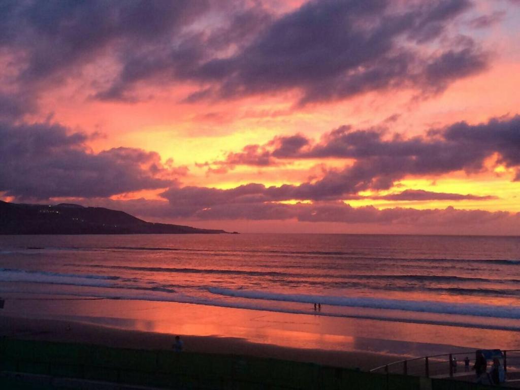 a sunset on a beach with the ocean at Numancia 1-4B in Las Palmas de Gran Canaria