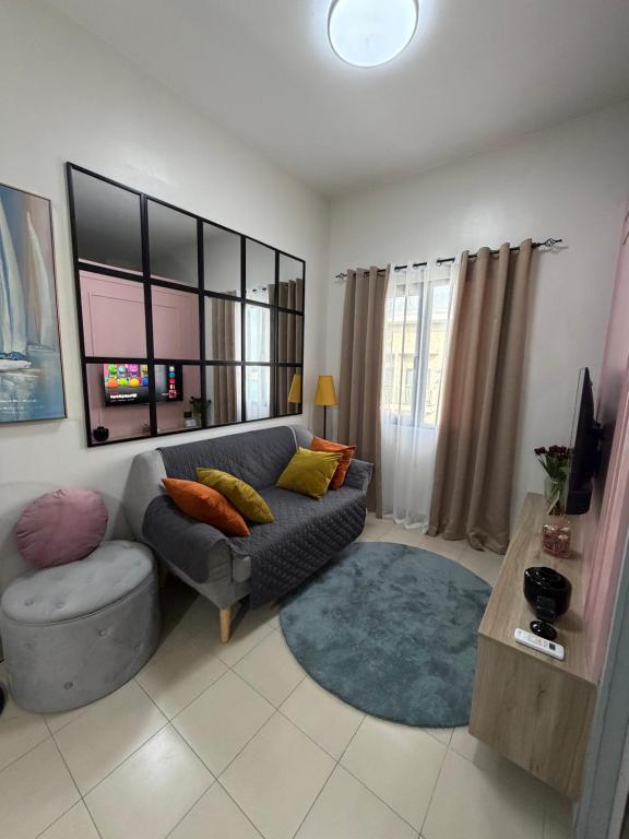 a living room with a couch and a table at 2BR Unit at Hill Residences I Free Parking in Manila