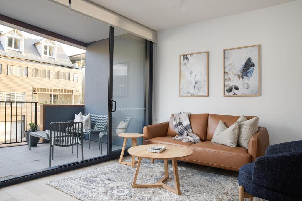 a living room with a couch and a table at The Ellery in Newcastle