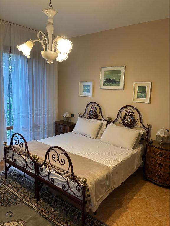 a bedroom with a bed and a chandelier at Borgo Caprari in Albinea