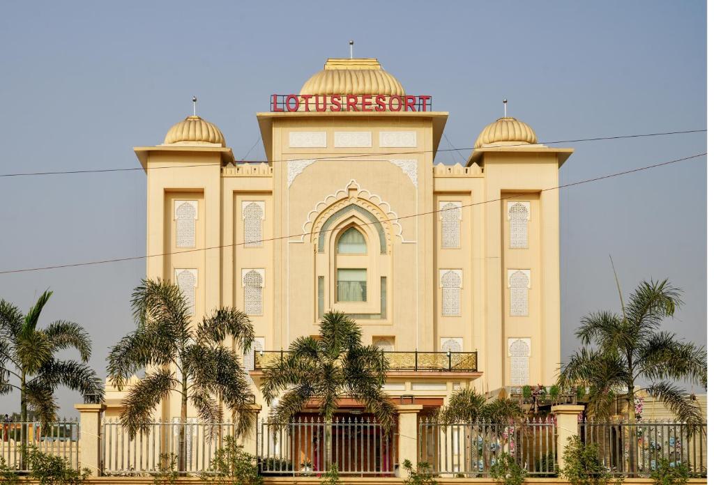 a large building with a tower on top of it at Lotus Resort in Raipur