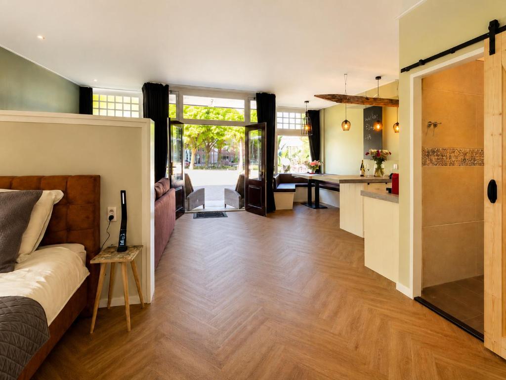 a large room with a bed and a kitchen at Appartement "Hartje Haamstede" in Burgh Haamstede