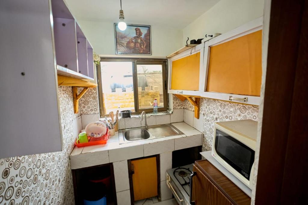 a small kitchen with a sink and a microwave at A & J Services in Tesa