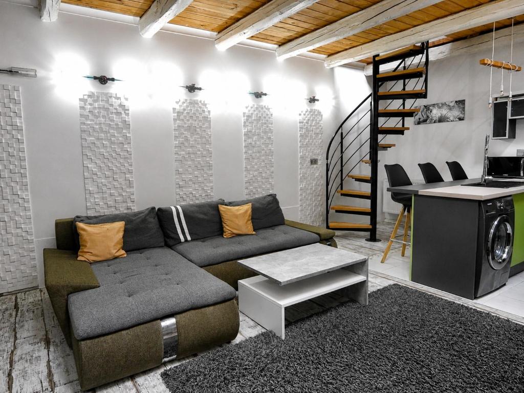 a living room with a couch and a table at Ady Házikó in Pécs