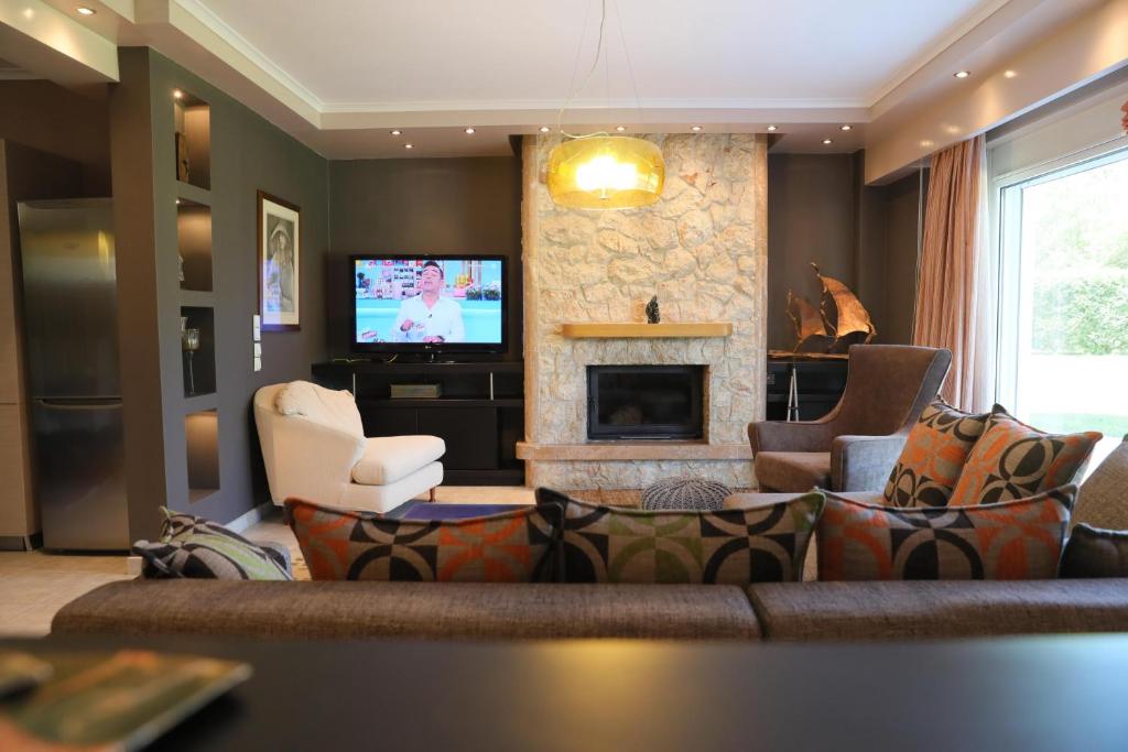 a living room with a couch and a fireplace at Luxury Heaven farm one in Kastoria