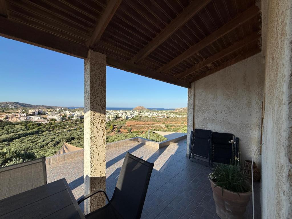 a patio with a table and chairs on a balcony at Kalithea Apartement in Palekastron