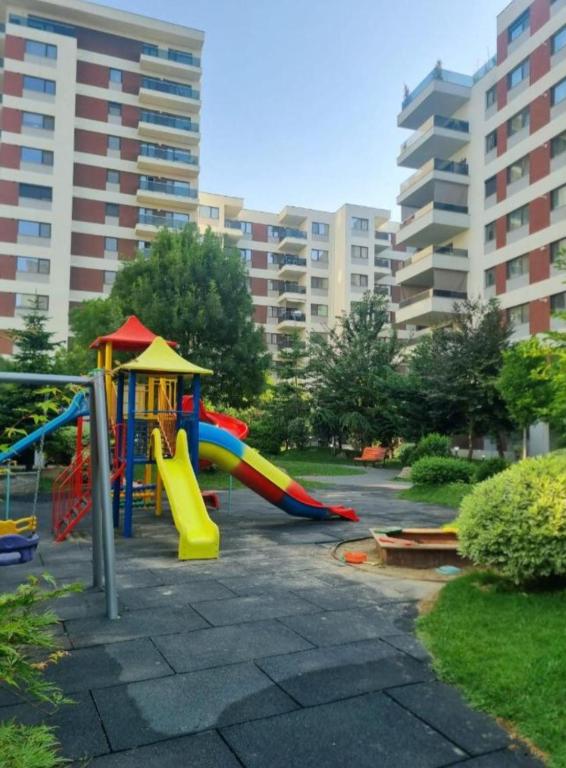 a playground in a park with a slide at Happy 2Rooms Apartament in Pipera
