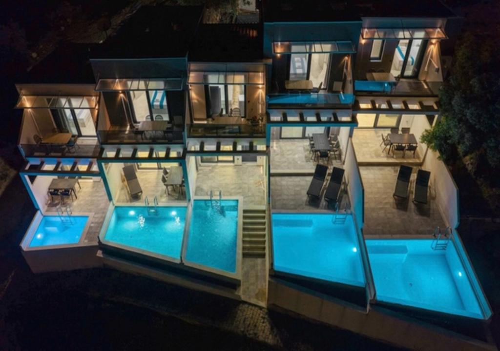 an aerial view of a building with a swimming pool at Villas Kaiafa “Ismini” in Polychrono