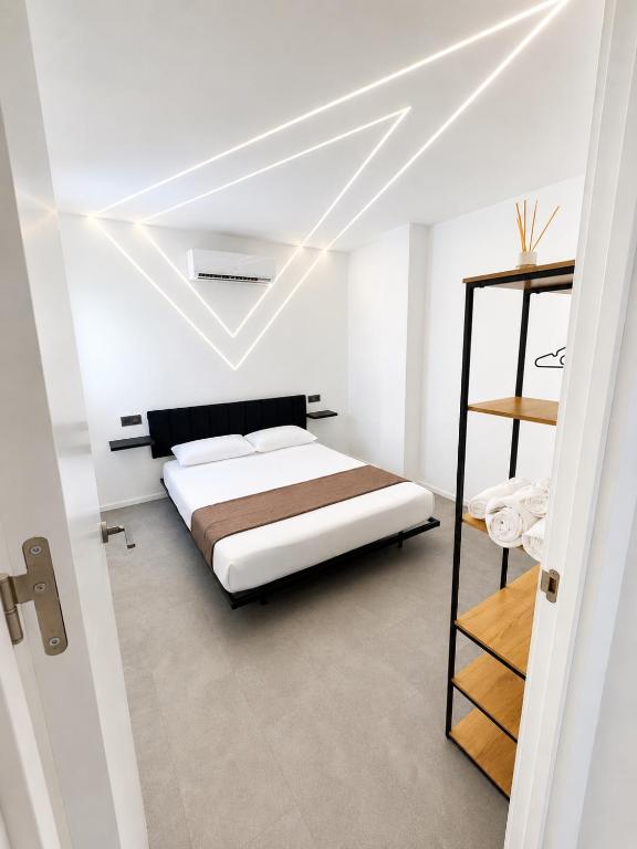 a bedroom with a bed in a white room at ApartamentosCRP in Almería