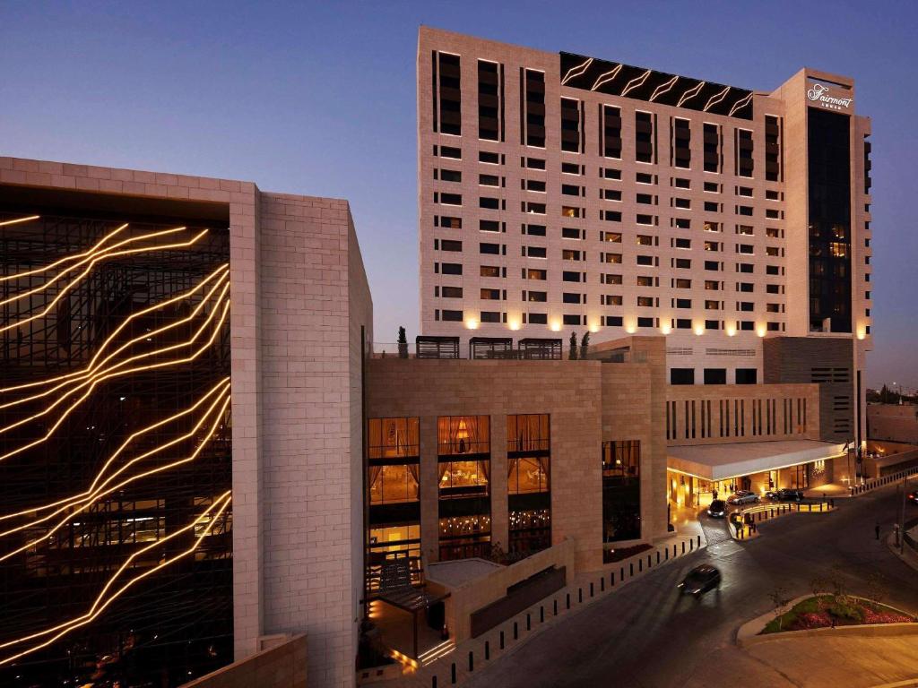 a large building with lights on the side of it at Fairmont Amman in Amman