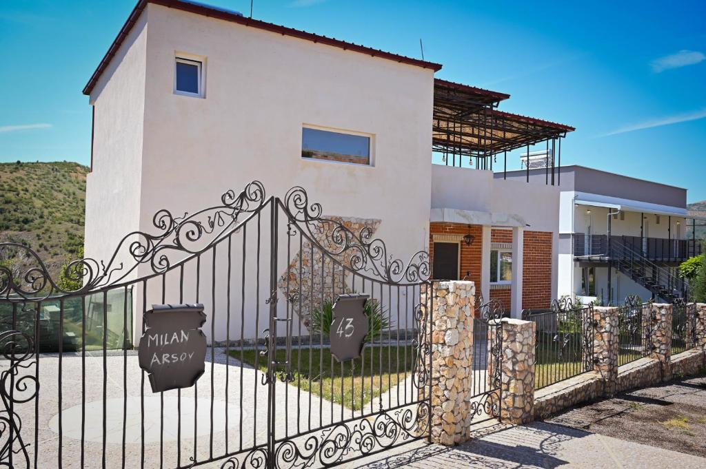 a white house with a black wrought iron gate at Villa Mladost Luxury in Veles