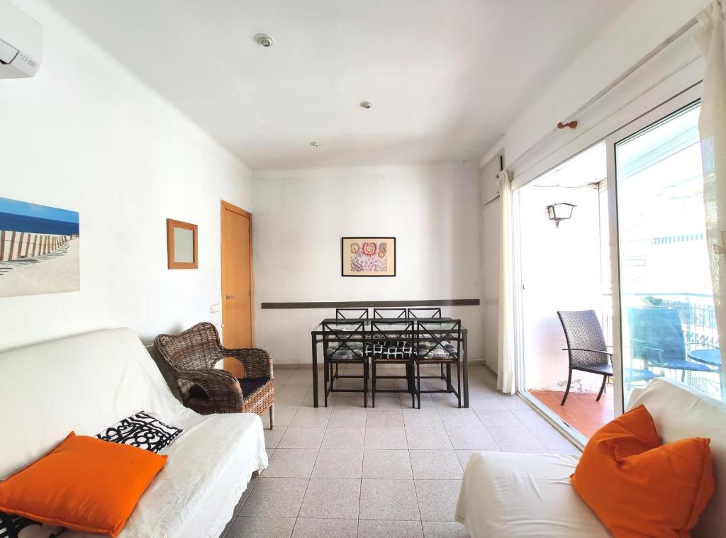 a living room with a couch and a table at Maribeach3 Sitges in Sitges