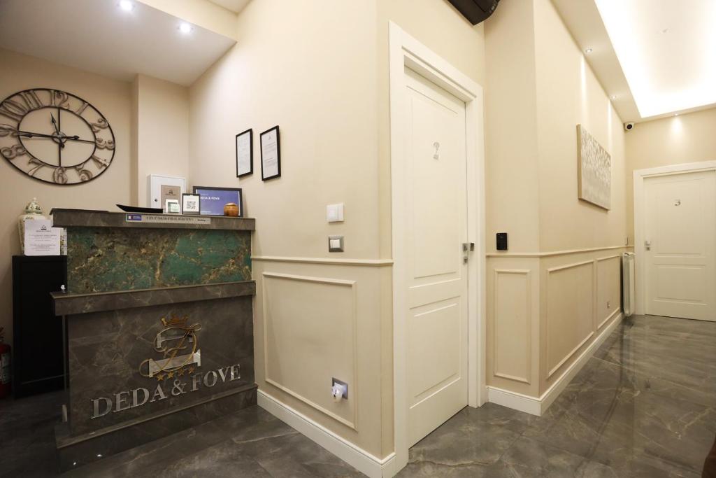 a hallway with a door and a clock on the wall at DEDA & FOVE in Naples