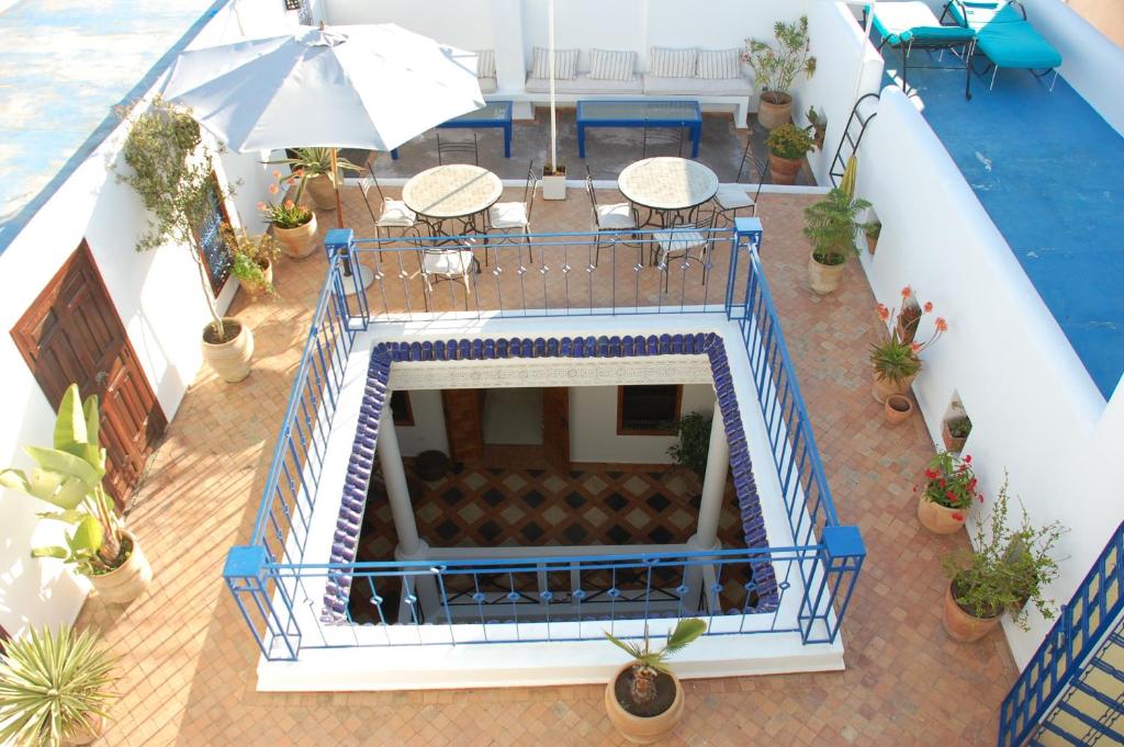 a white and blue room with a balcony at Riad Dar Soufa in Rabat