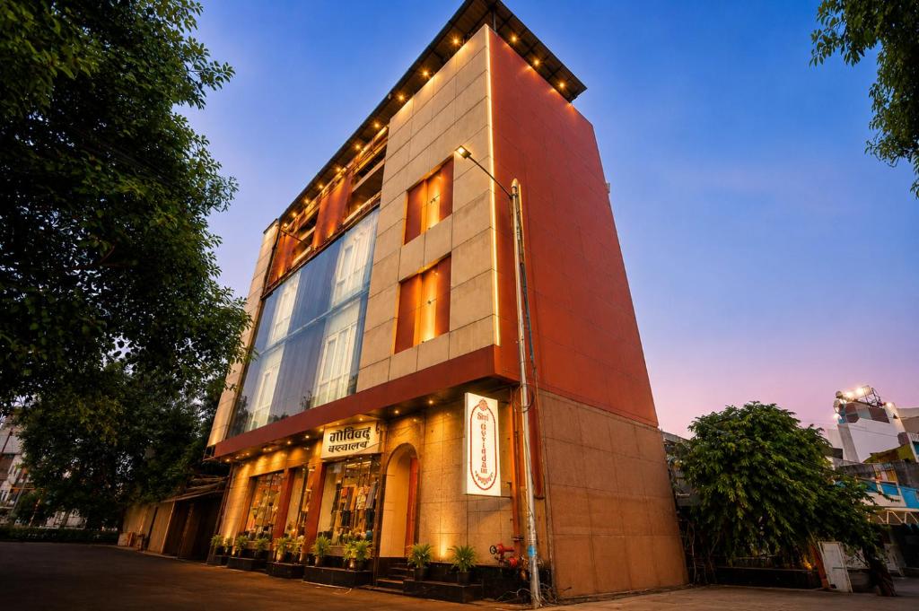 a building with lights on the side of it at Hotel Shri Govindam Banaras with Parking in Varanasi