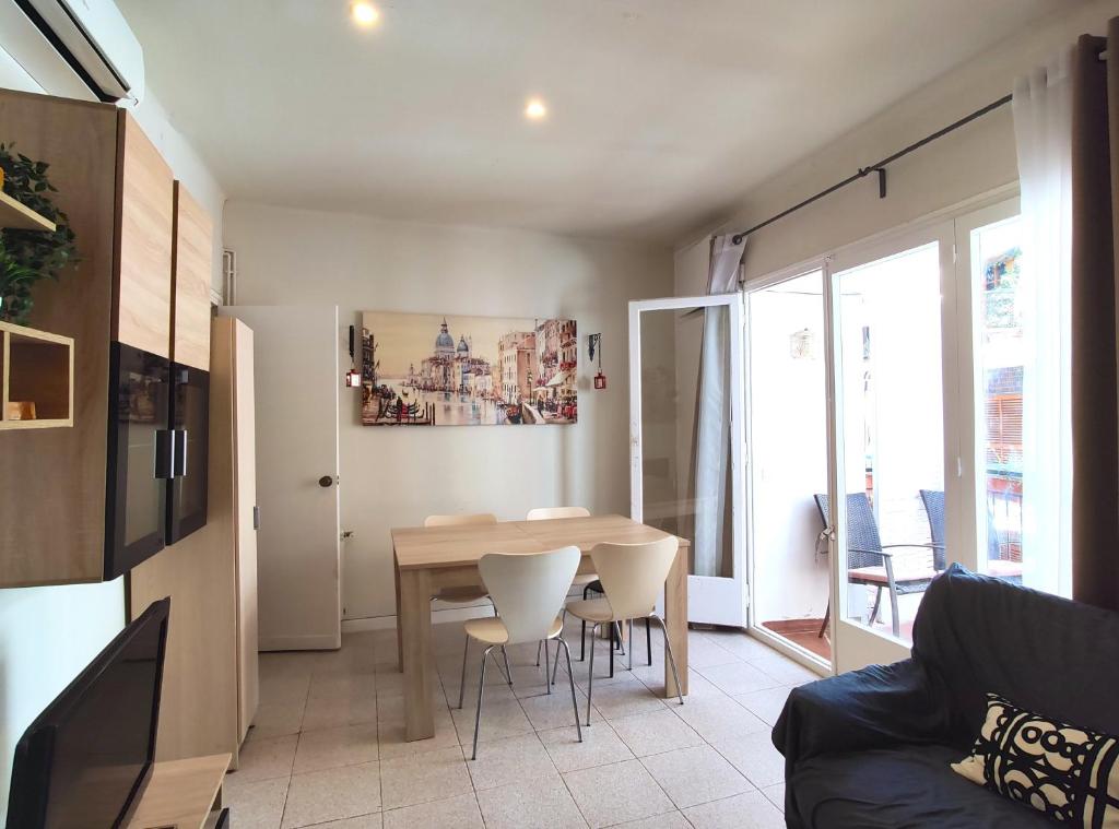 a kitchen and living room with a table and chairs at Maribeach2 Sitges in Sitges