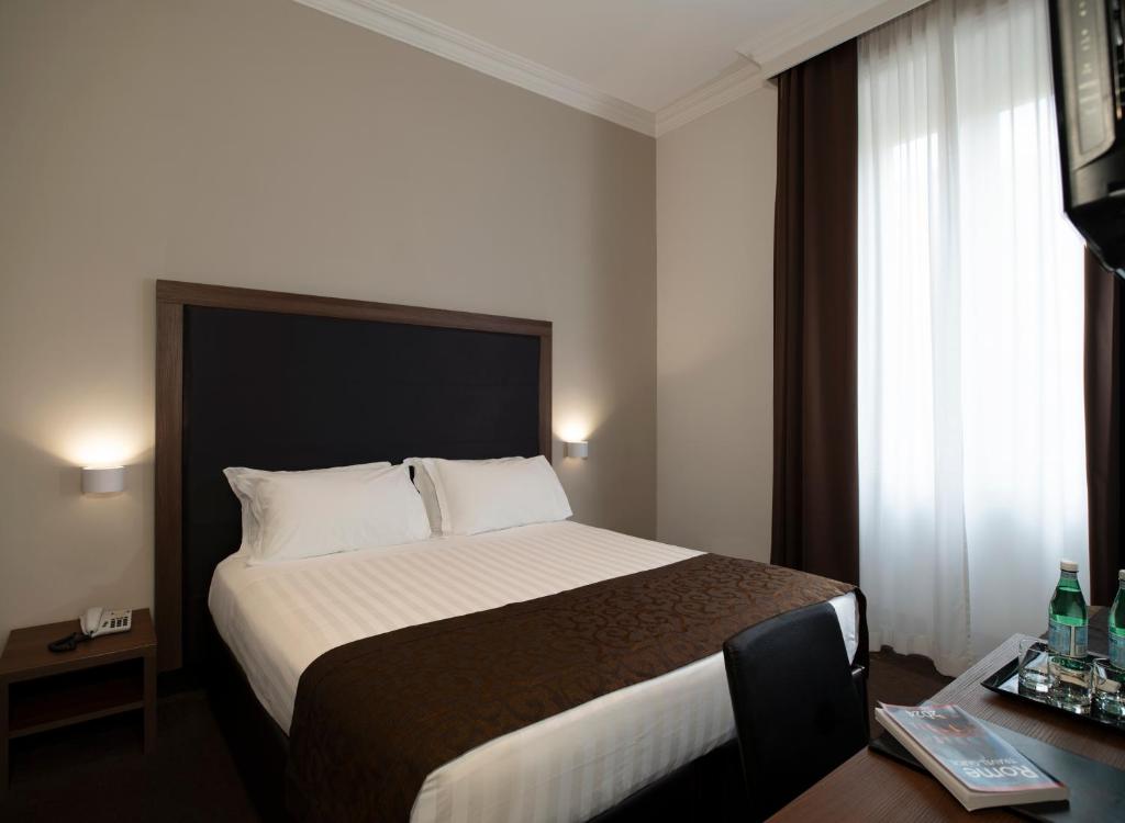 a bedroom with a large bed in a hotel room at Rome Garden Hotel in Rome