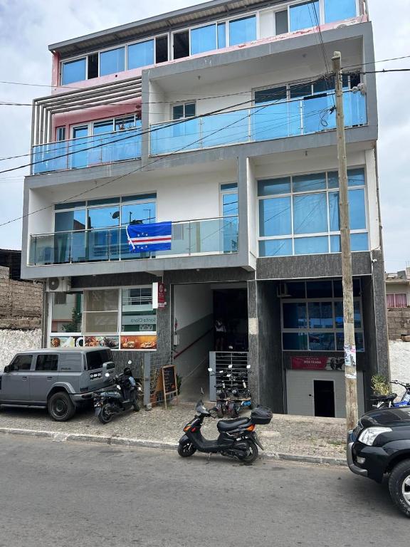 a building with motorcycles parked in front of it at My Flat 2 in Praia