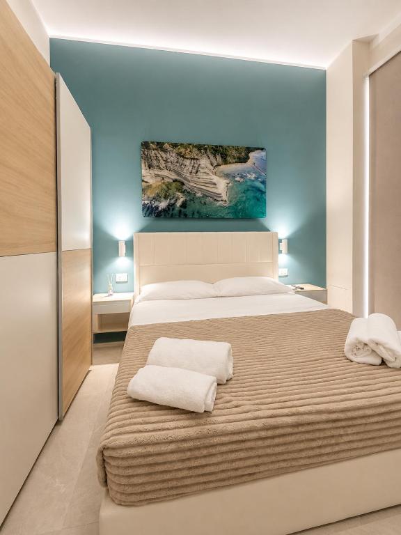 a bedroom with a large bed with two towels on it at Maison Sicilienne in Turin