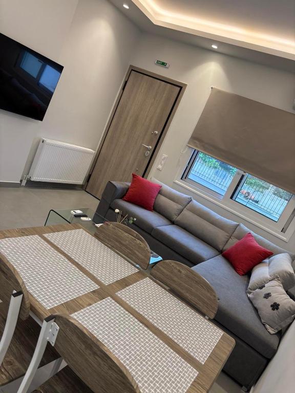 a living room with a couch and a table at Fabio apartment in Amarynthos