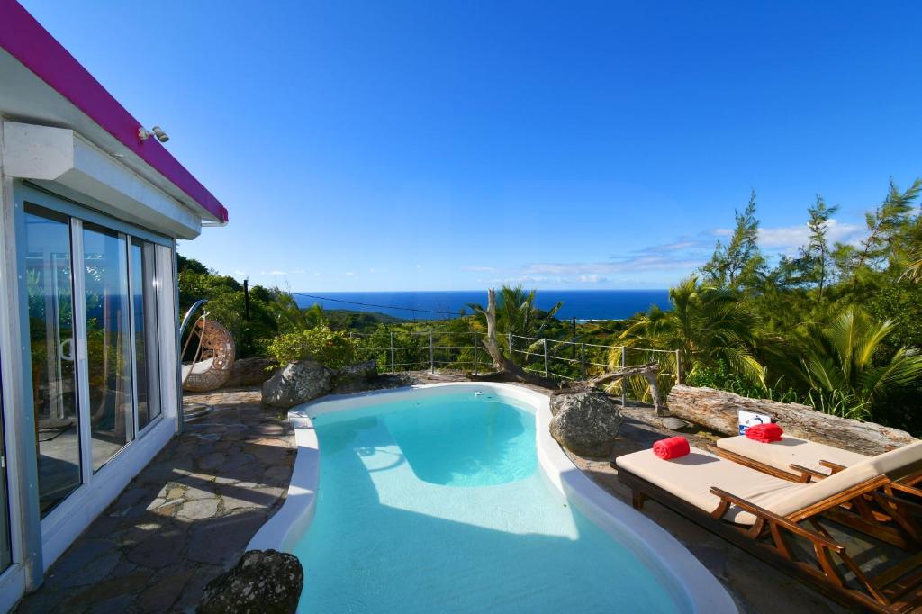 a swimming pool with a view of the ocean at Villa Lorizon in Rodrigues Island