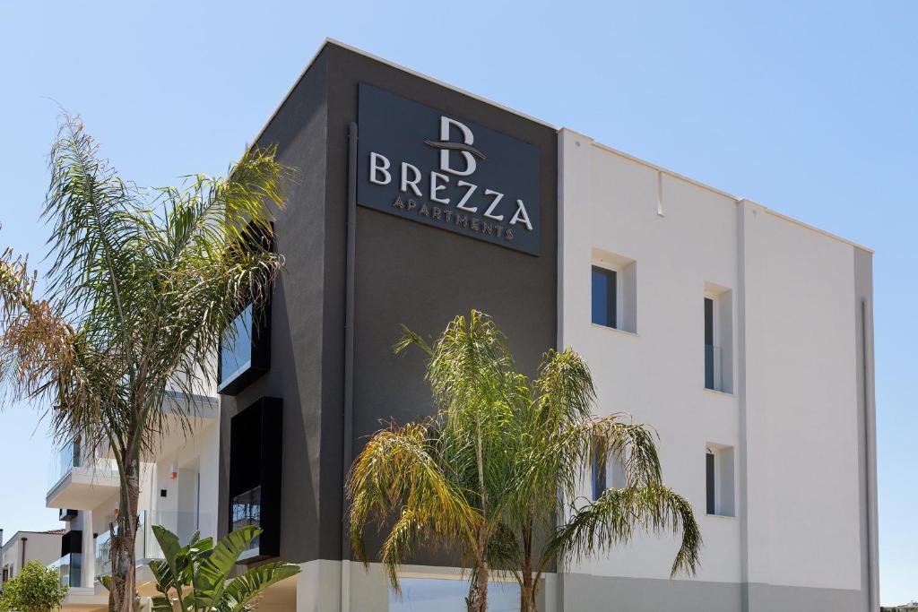a building with a black sign on the side of it at Brezza Apartments in Santa Flavia