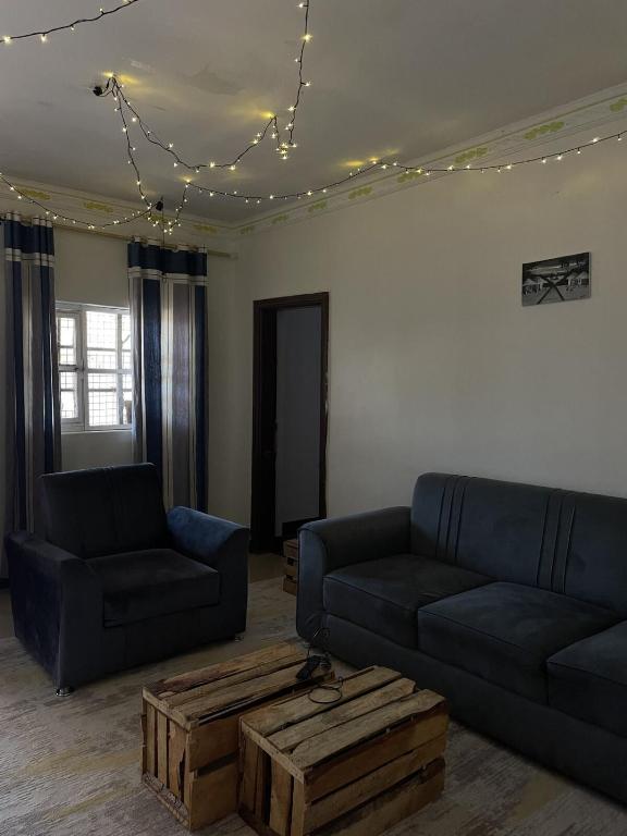 a living room with two couches and a coffee table at Belalonte House, Iringa in Iringa