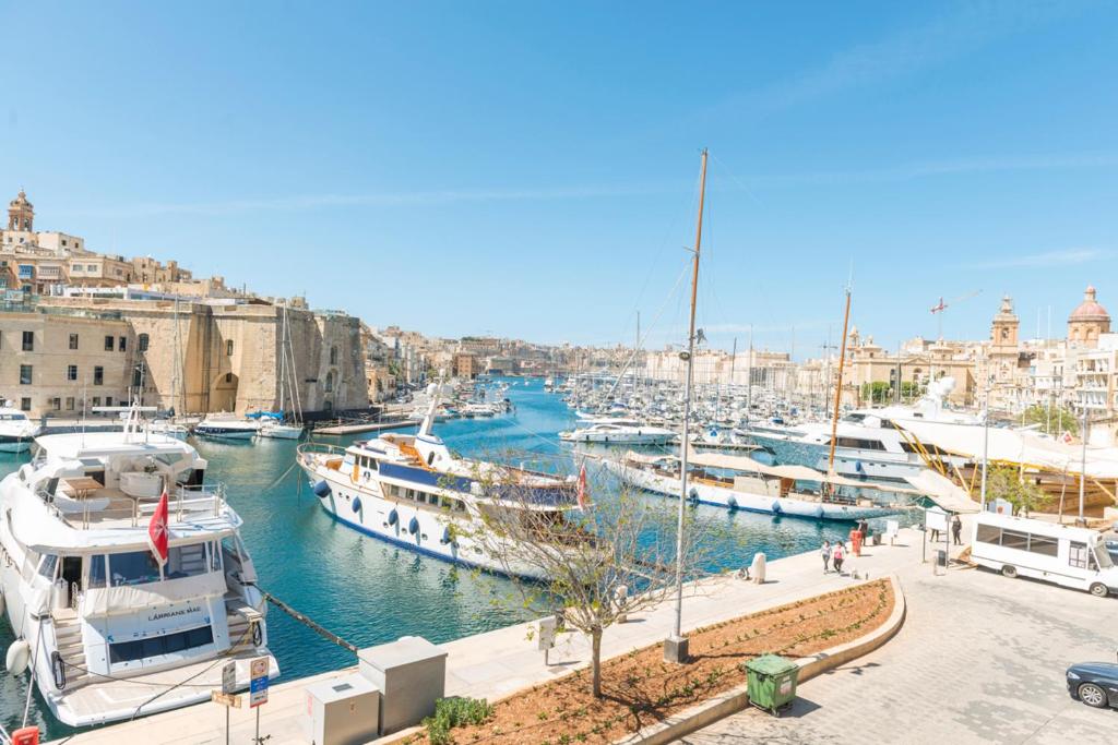 a group of boats docked in a harbor at Room in Historic Knights House at the Marina in Senglea