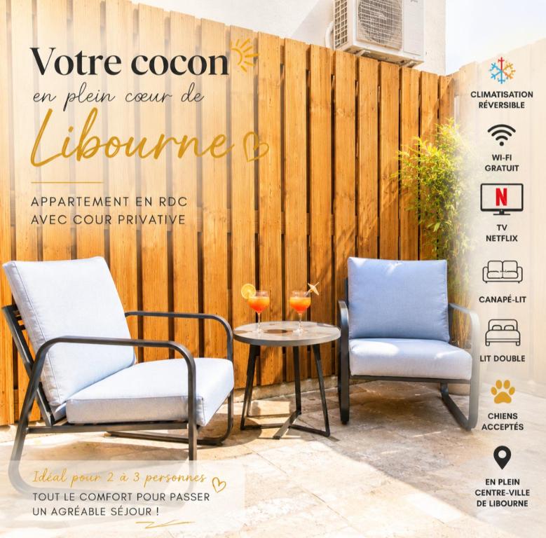 two chairs and a table in front of a fence at Apparts Gambetta in Libourne
