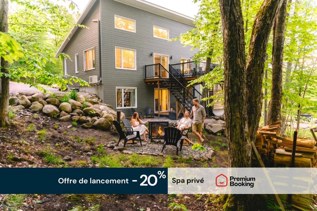 a group of people standing in front of a house at Java with Private Spa & Games, Lake & Golf in Saint-Raymond