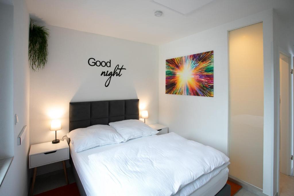 a bedroom with a bed and a painting on the wall at Walters Weidelbach in Haiger