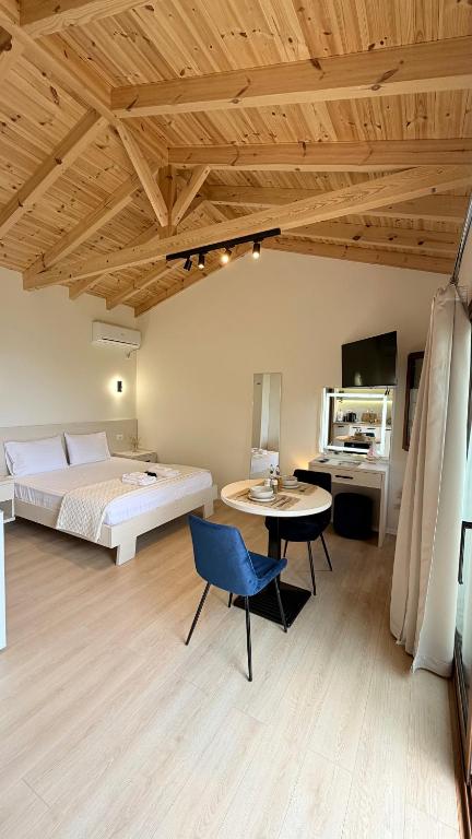 a bedroom with a bed and a table and a chair at Aurea in Dhërmi
