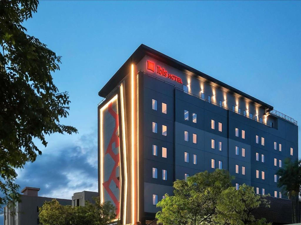 a building with a sign on the side of it at ibis Surabaya Tidar in Surabaya