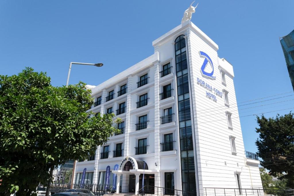 a white building with a cross on top of it at Dorana Toro Hotel in Kyrenia