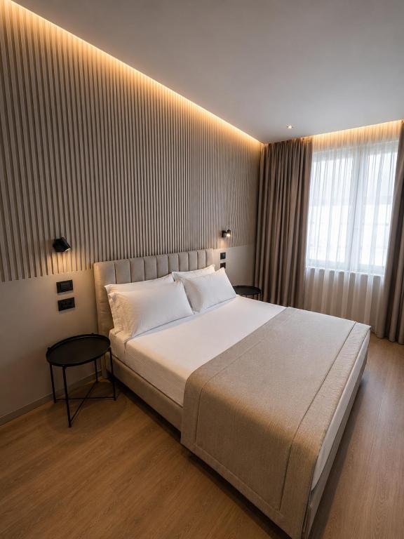 a bedroom with a large bed and a window at The Q House in Foligno