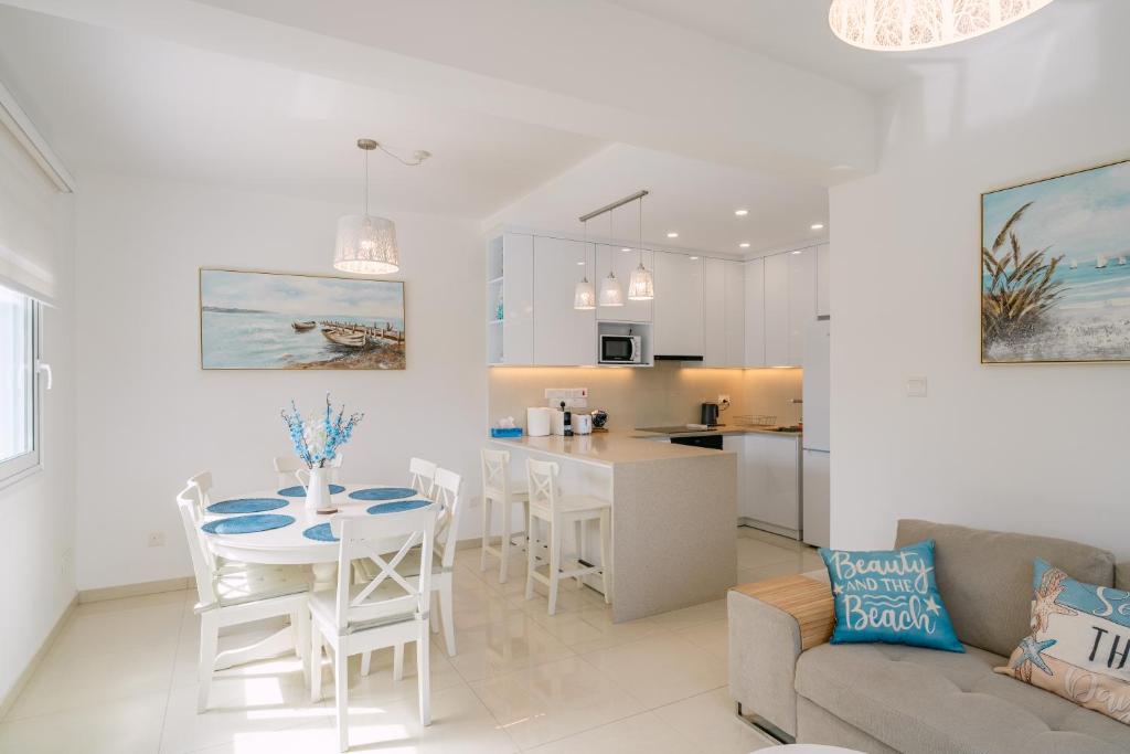 a kitchen and living room with a table and chairs at Myrtiana 10 in Oroklini
