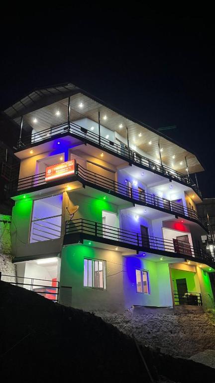 a lit up building with lights on it at night at Trishool inn residency in Chandrāpuri