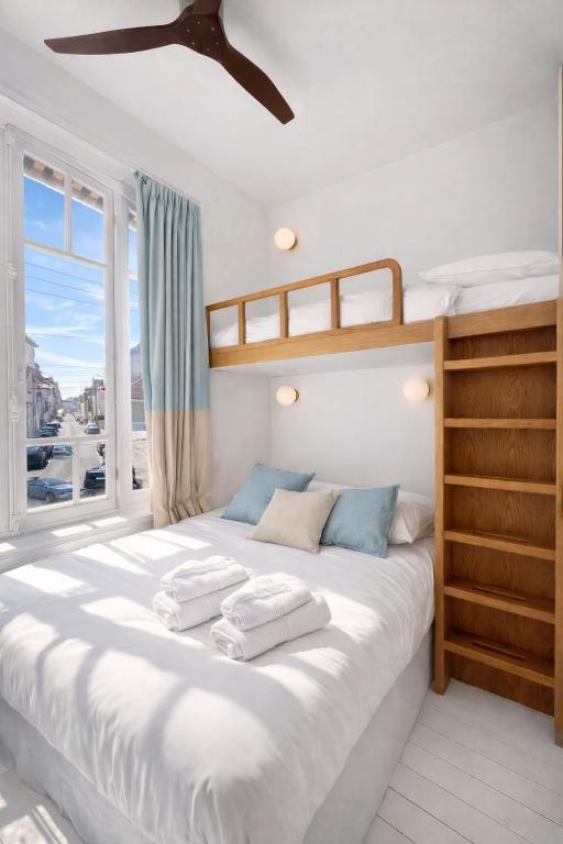 a bedroom with a bed with two towels on it at Villa La Rafale plage centre 300 m in Le Touquet-Paris-Plage
