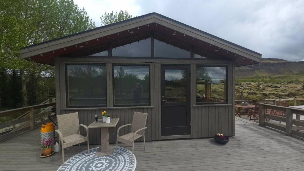 a gazebo with a table and chairs on a deck at A cosy 2 bedroom cabin with an amazing view in Borgarnes